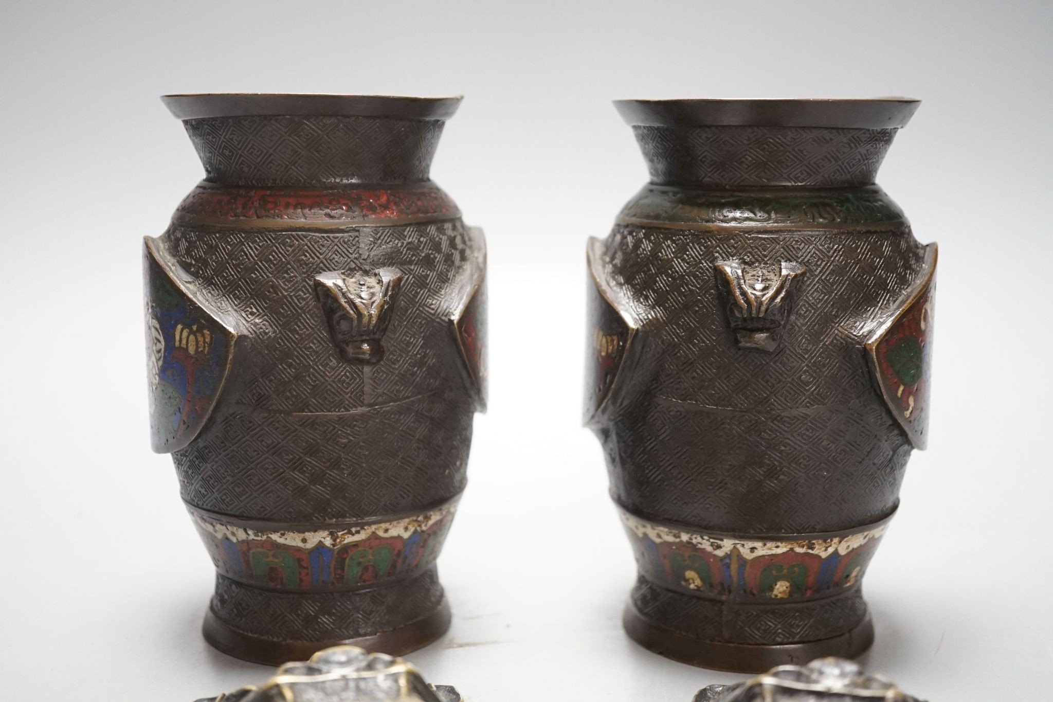 A pair of Chinese cast brass mask ring handles and a pair of Japanese enamelled bronze vases, 15 cm